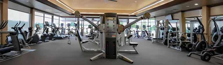Wide view of a commercial fitness center with cardio and strength equipment