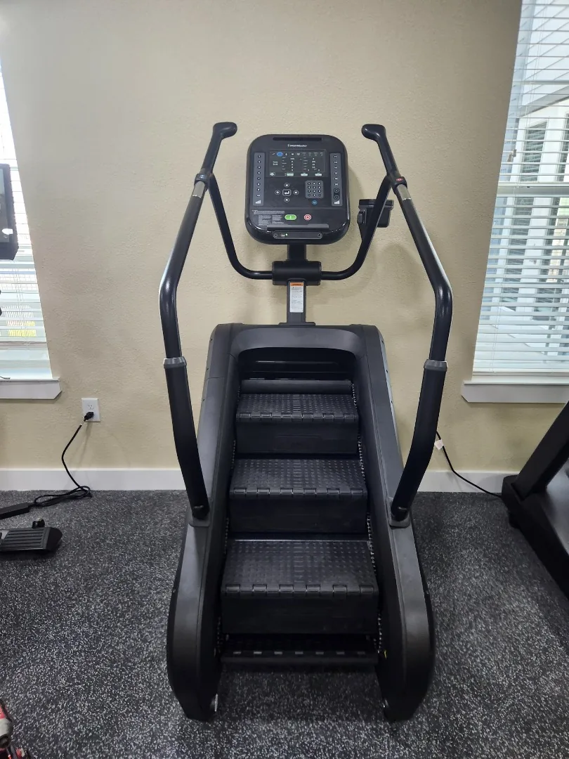 Front view of a StairMaster 4G StepMill stair climber in a fitness room