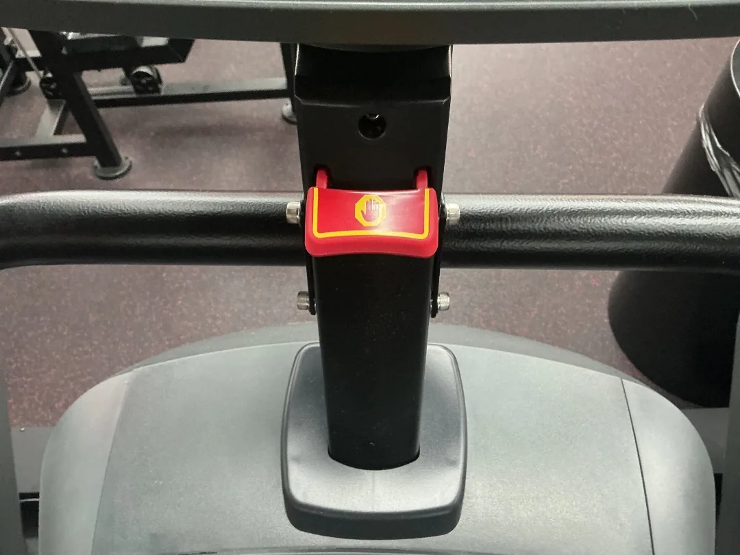 Red emergency-stop safety clip on the handlebar of a Matrix ClimbMill stair climber