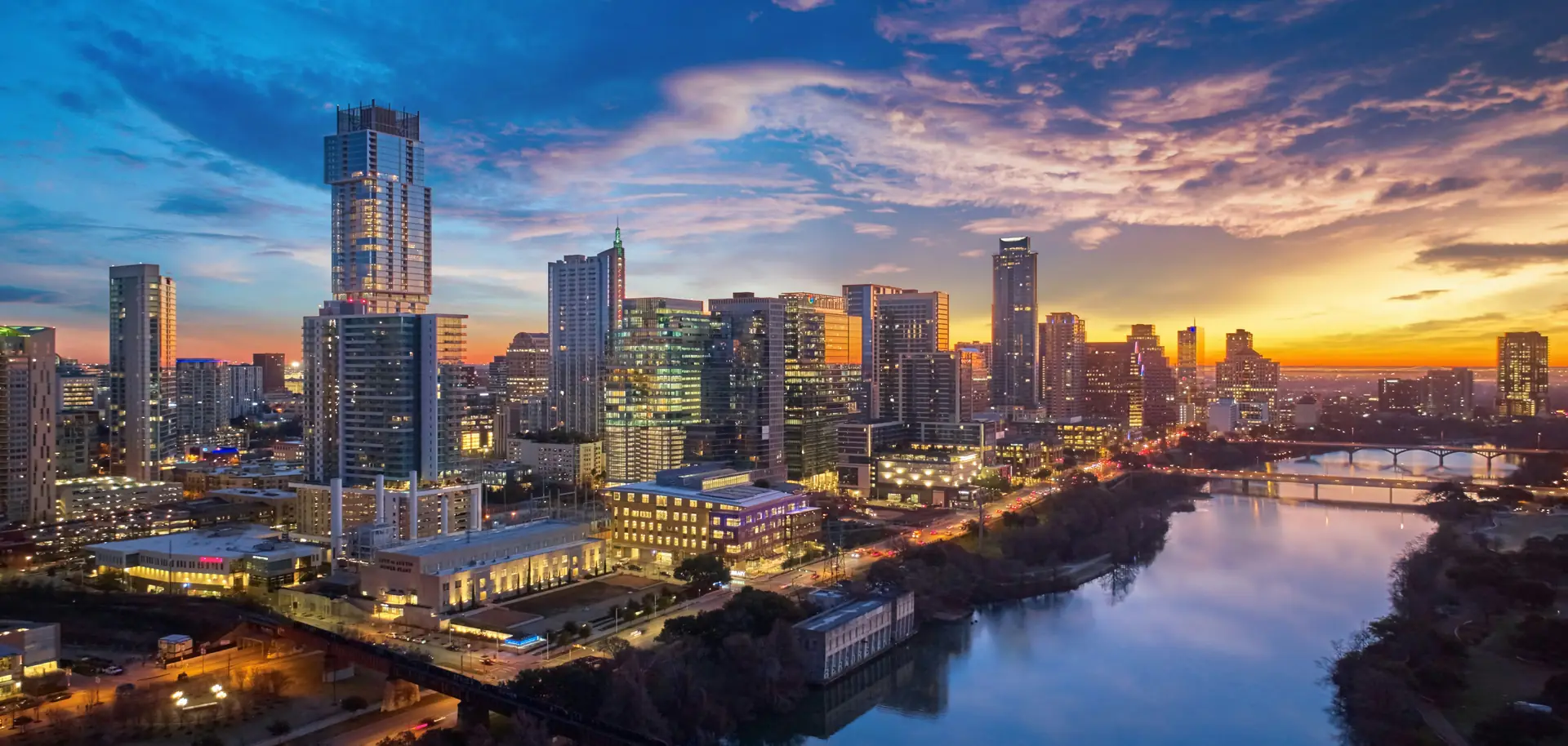 Downtown Austin skyline at sunrise above Lady Bird Lake and its bridges