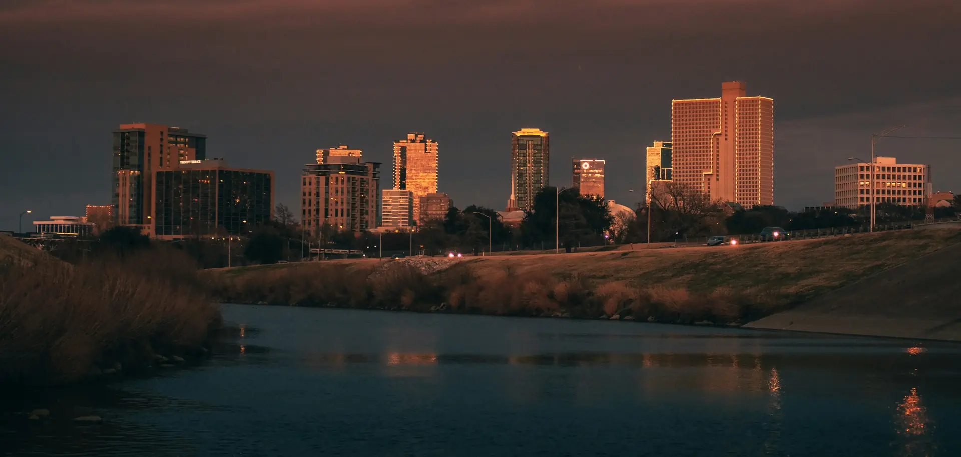 Downtown Fort Worth towers lit by the evening sun above the Trinity River